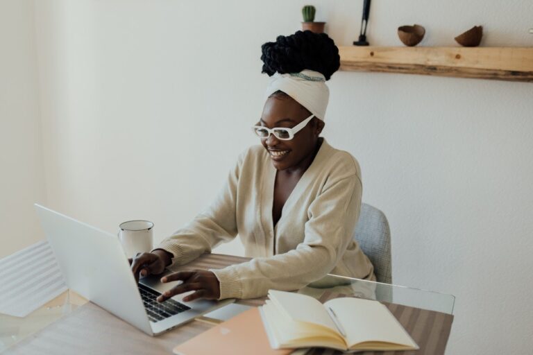 Black woman using laptop at desk